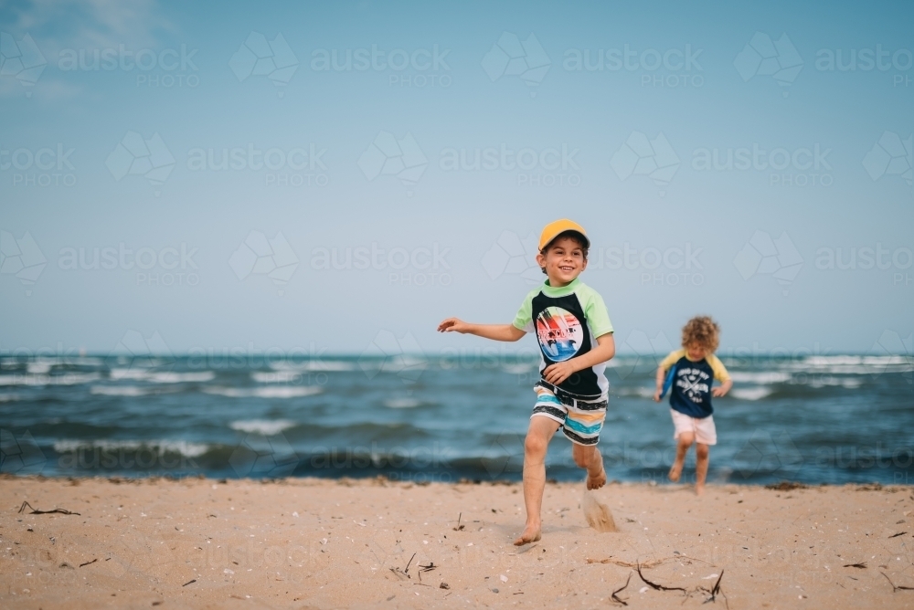 Boys playing on the beach - Australian Stock Image
