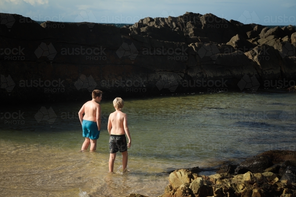Boys swimming at The Tanks rocky tourist attraction at Forster, NSW Australia - Australian Stock Image