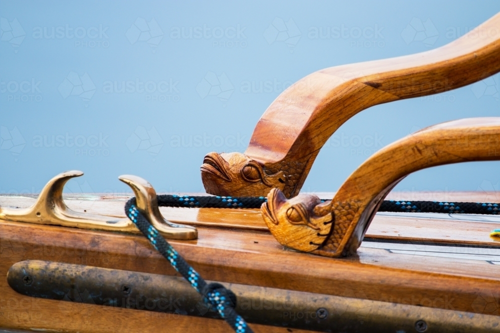 Brass fitting with rope and wooden carving on boat - Australian Stock Image