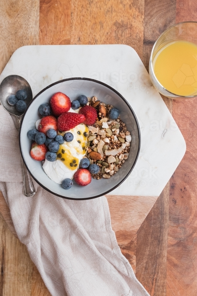 Breakfast bowl and juice from above. - Australian Stock Image