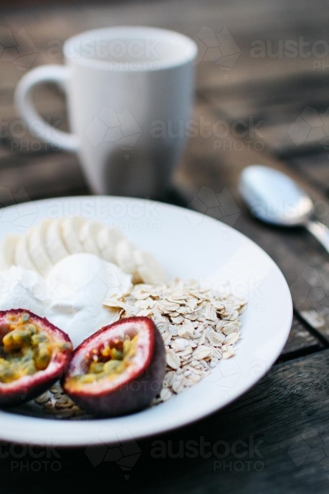 Breakfast Detail with Fruit and Yoghurt on Table - Australian Stock Image