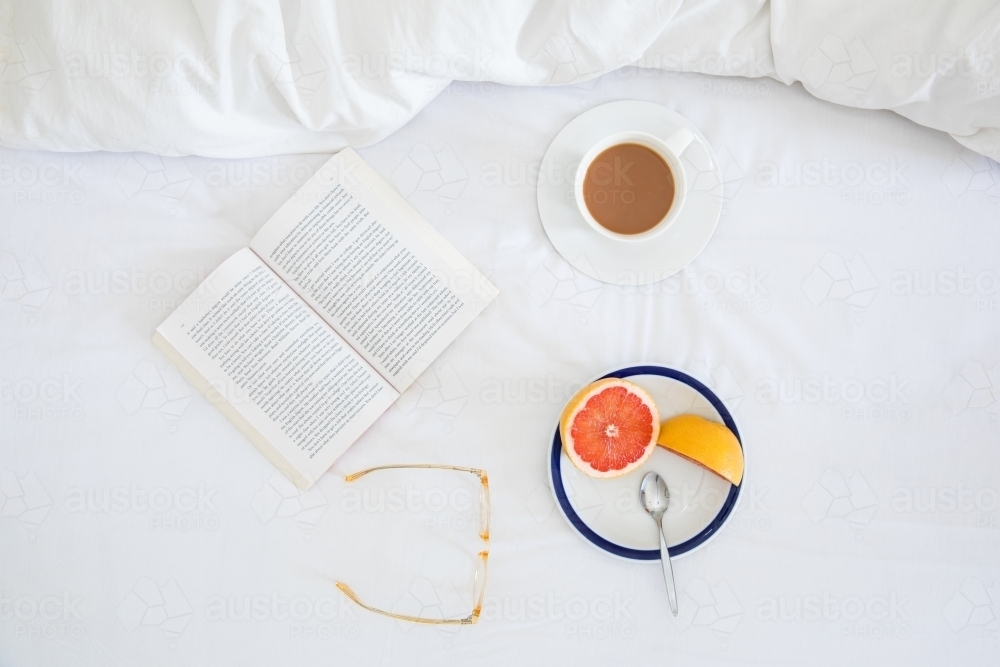 Breakfast flatlay on white bedspread - Australian Stock Image