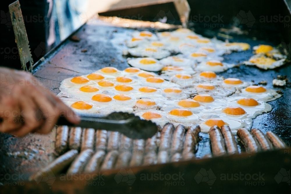 Breakfast sausages and eggs on the bbq - Australian Stock Image