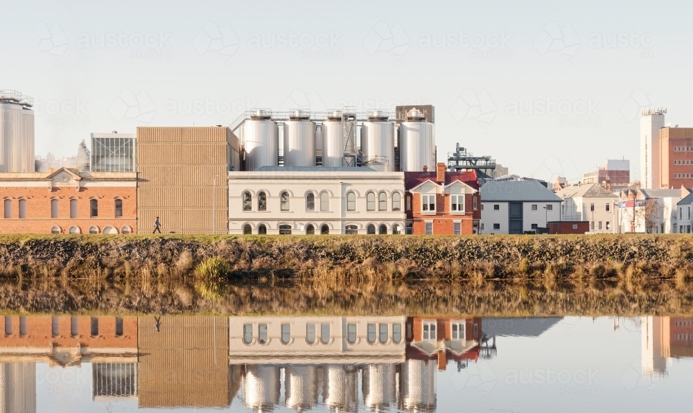 Brewery building on the side of the Tamar River, the building is reflected on the rivers surface - Australian Stock Image