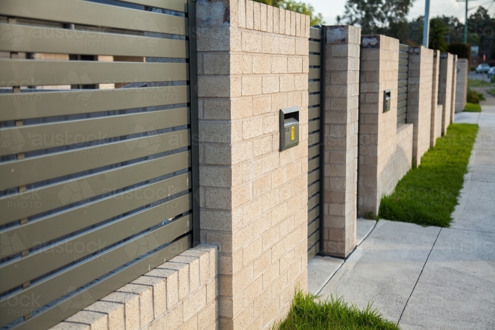 Brick gateways and fence outside urban terrace homes - Australian Stock Image