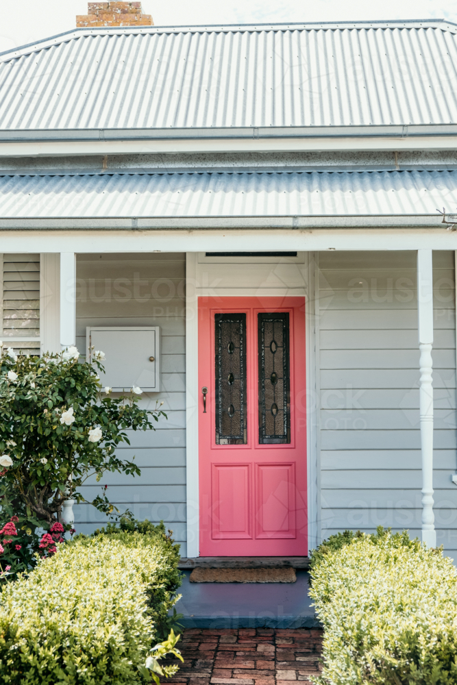 Brick pathway leading towards the pink cottage door - Australian Stock Image