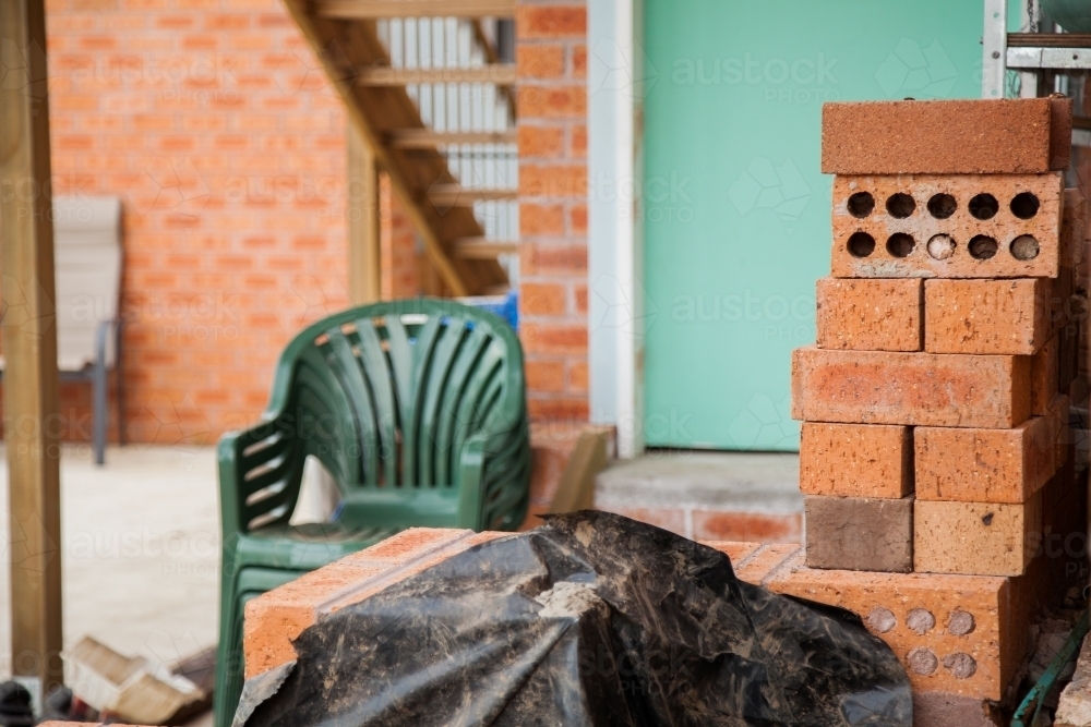 Bricks piled beside a house under construction - Australian Stock Image
