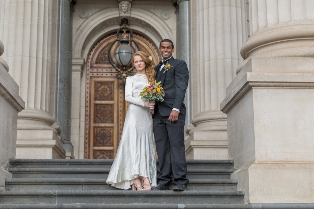 Bridal photos couple together on stairs - Australian Stock Image