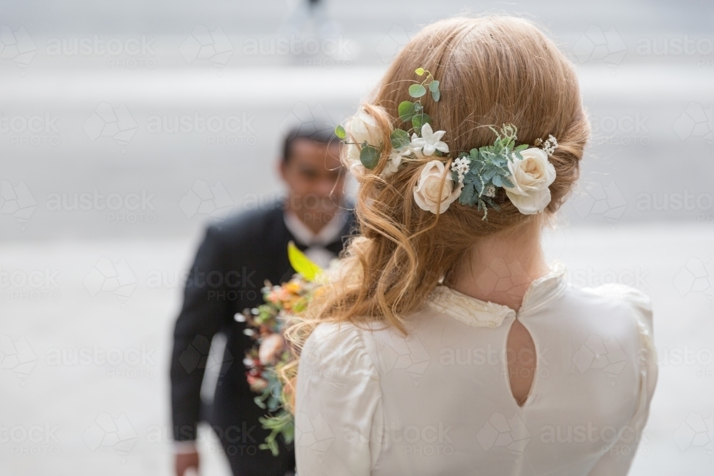 Bridal photos flowers in hair first look - Australian Stock Image