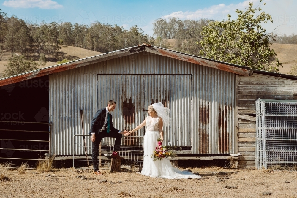 Bride and Groom in front of old shed - Australian Stock Image