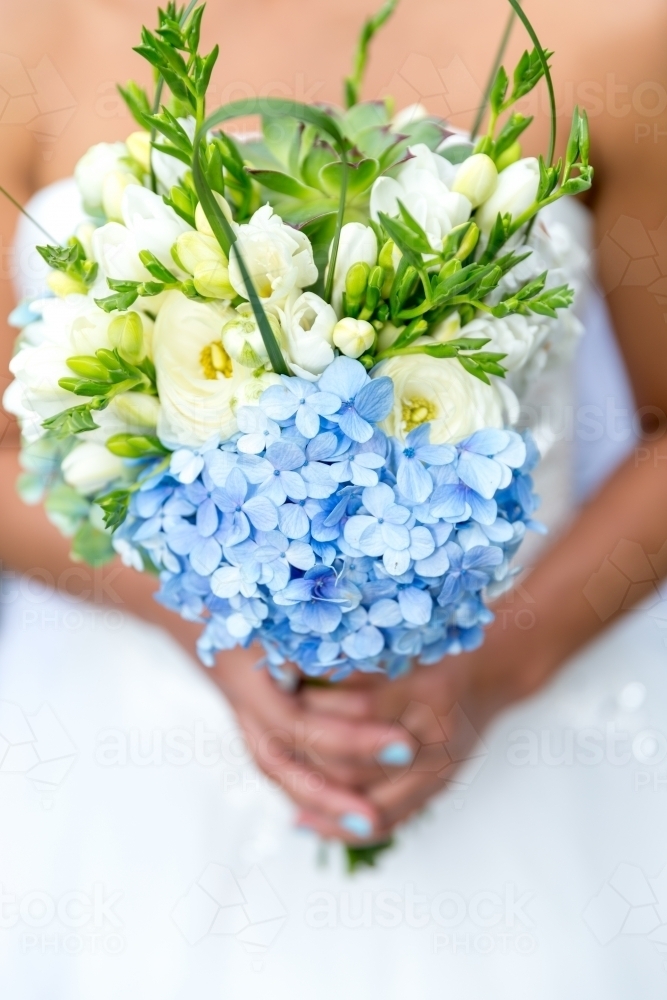 Bride holding flowers on wedding day - Australian Stock Image