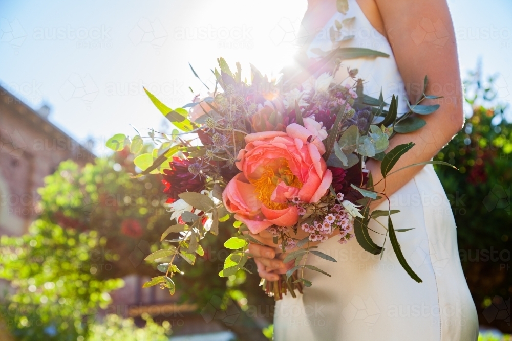 Bride holding large wedding bouquet of native australian flowers - Australian Stock Image