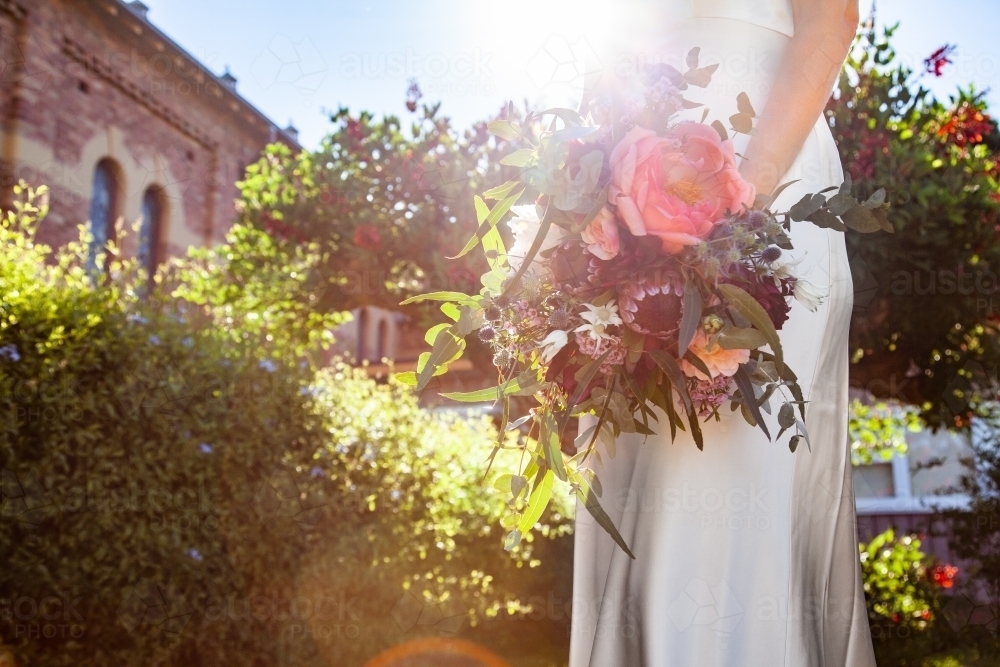 Bride holding large wedding bouquet of native australian flowers - Australian Stock Image