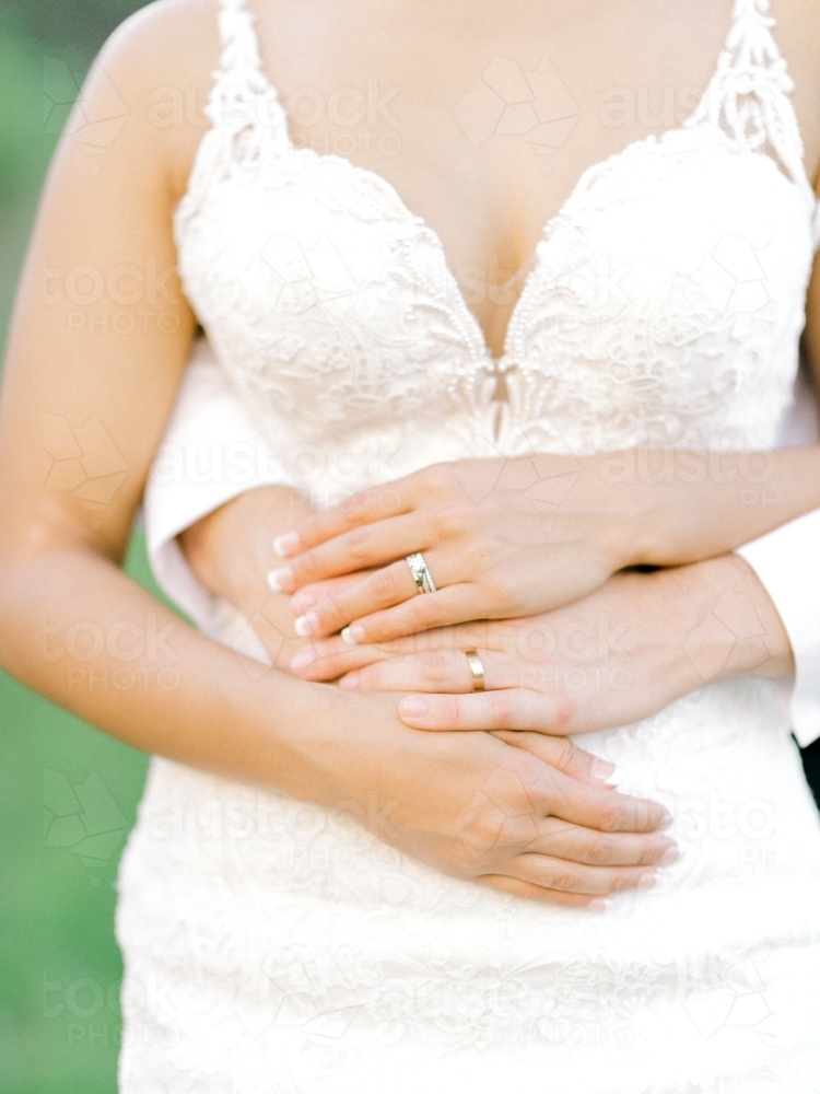 Bride torso with arms wrapped around her - Australian Stock Image
