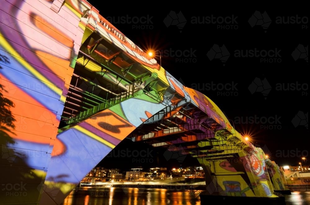 Bridge lit up at night with laser light images - Australian Stock Image