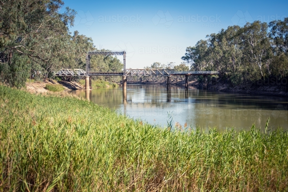 Bridge over the Murray River with green grass in the foreground. - Australian Stock Image