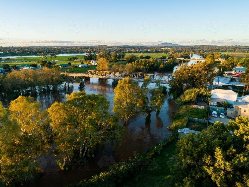 Bridges into town over flooded river in Hunter Valley - Australian Stock Image