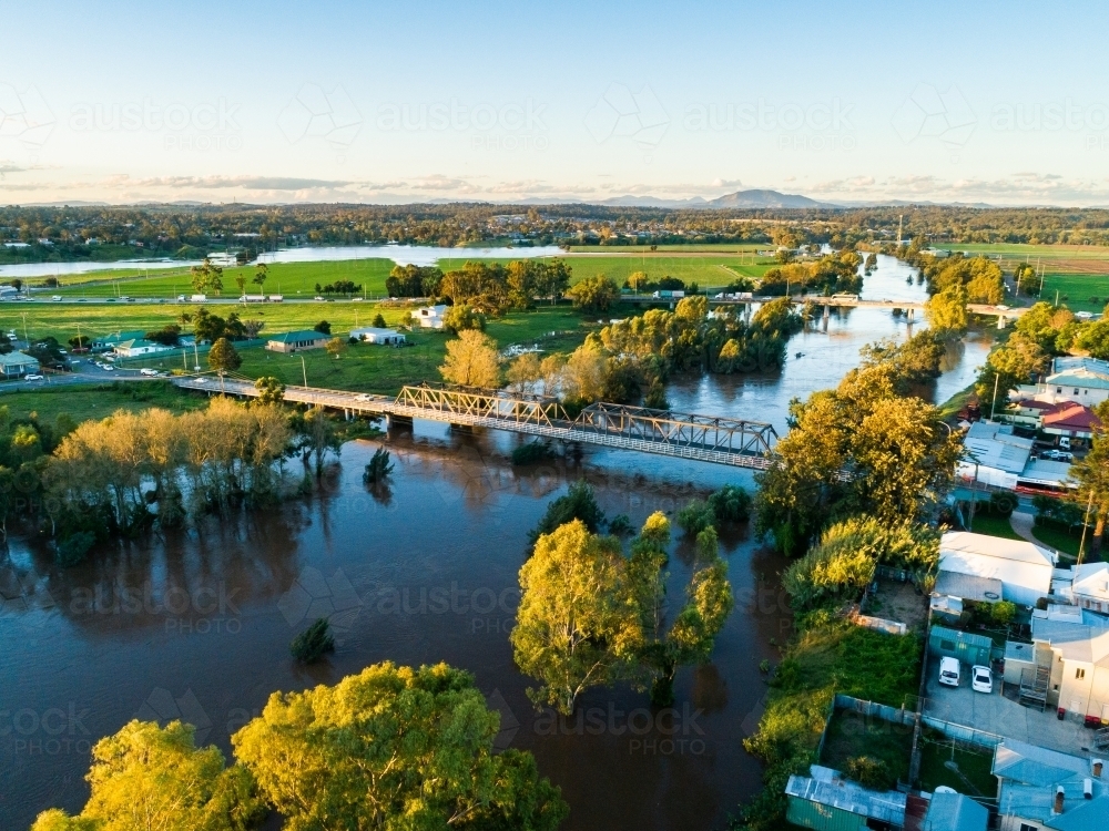Bridges into town over flooded river in Hunter Valley - Australian Stock Image