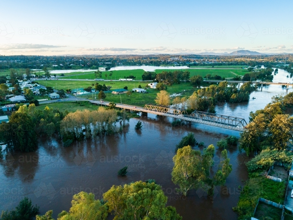 Bridges into town over flooded river in Hunter Valley - Australian Stock Image