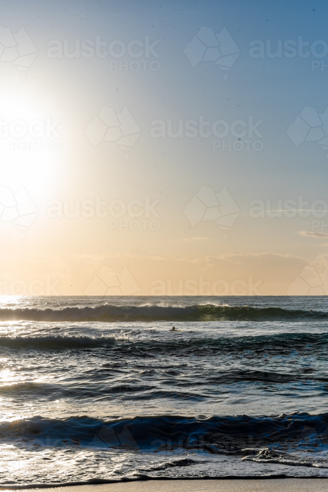 Image of Bright Sun Glare Over Ocean Waves at Beach - Austockphoto
