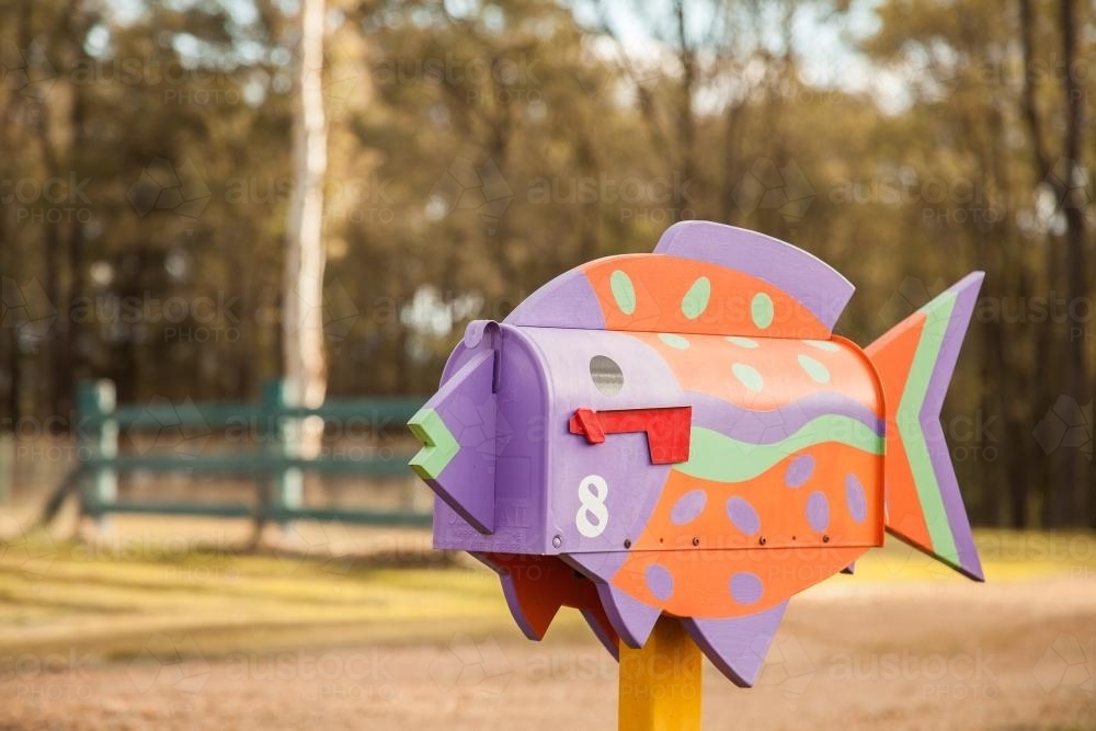 Brightly coloured fish mailbox in rural location - Australian Stock Image