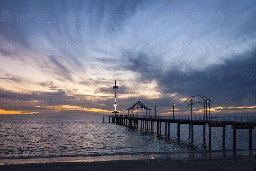 Brighton Jetty by the sea on a dark sunset - Australian Stock Image