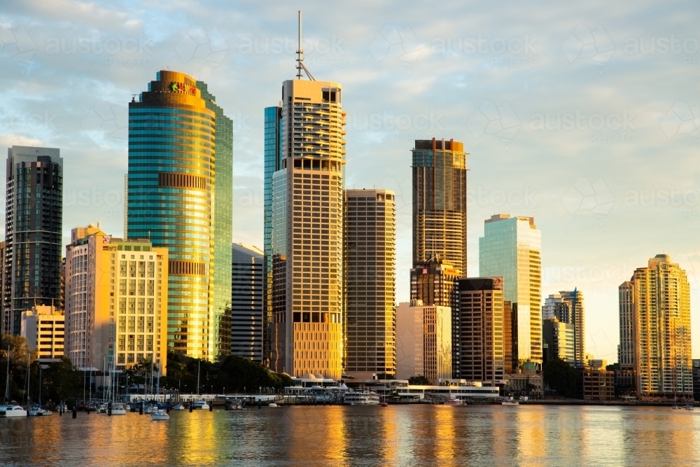 Brisbane buildings reflecting golden sunlight in the early morning - Australian Stock Image