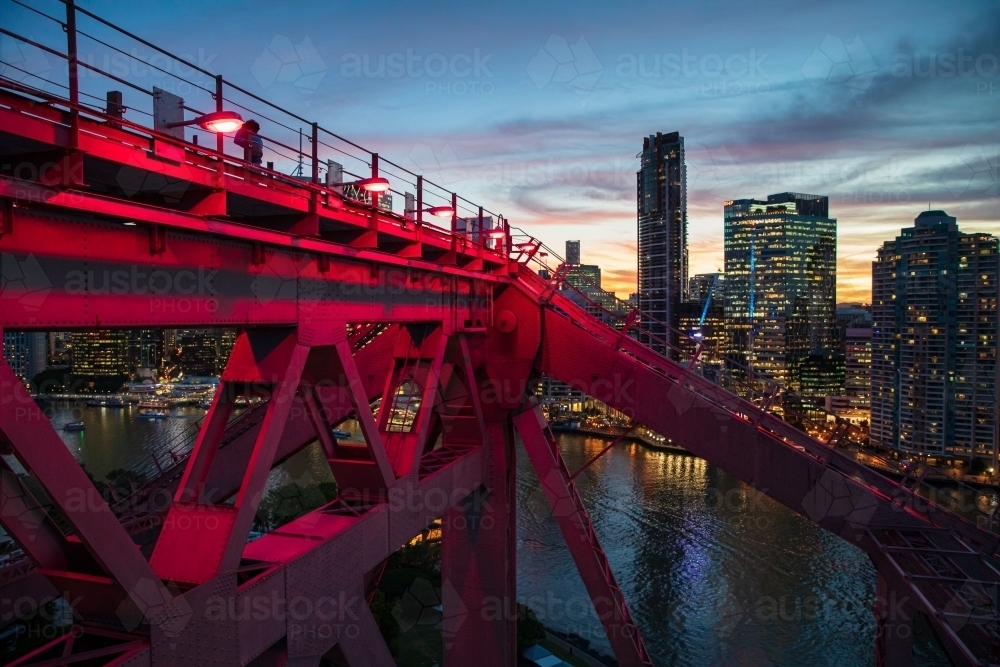 Brisbane CBD and the red illuminated structure of part of the Story Bridge at dusk. - Australian Stock Image