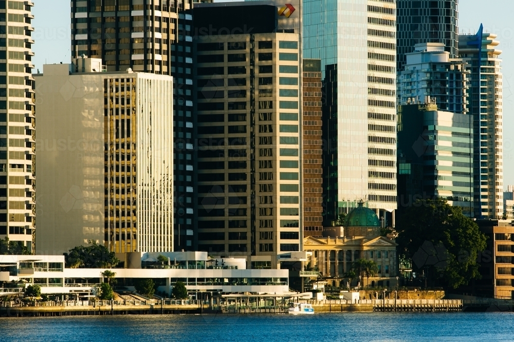 Brisbane River and city buildings along the riverfront early in the morning - Australian Stock Image