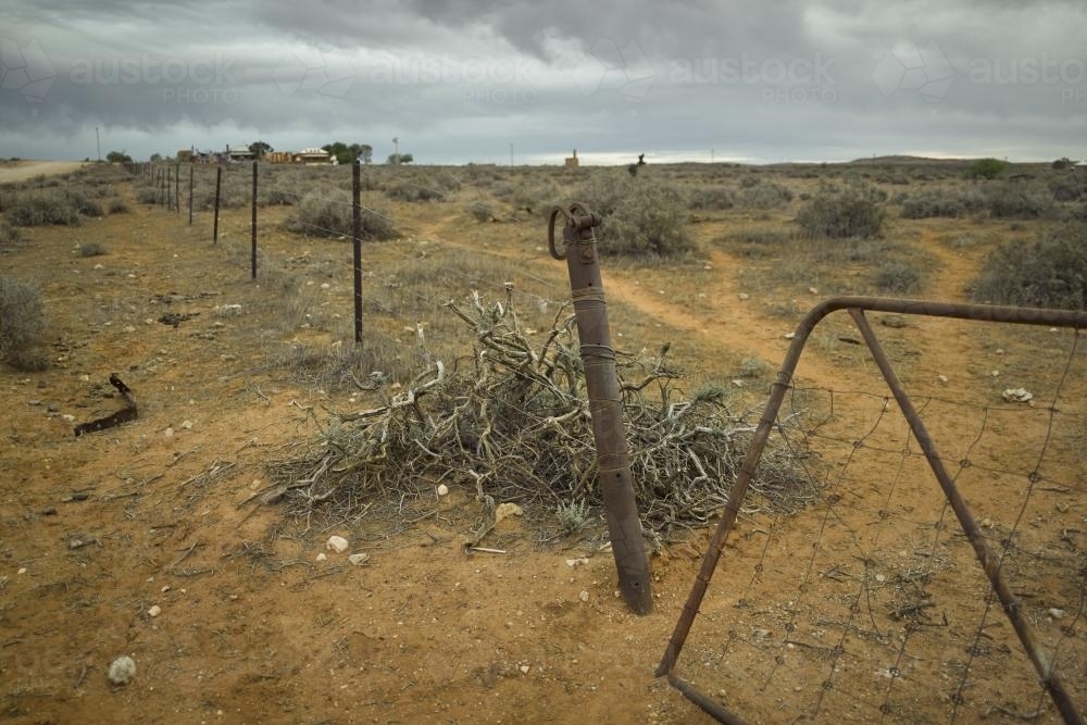 Broken gate and fence line in the outback - Australian Stock Image