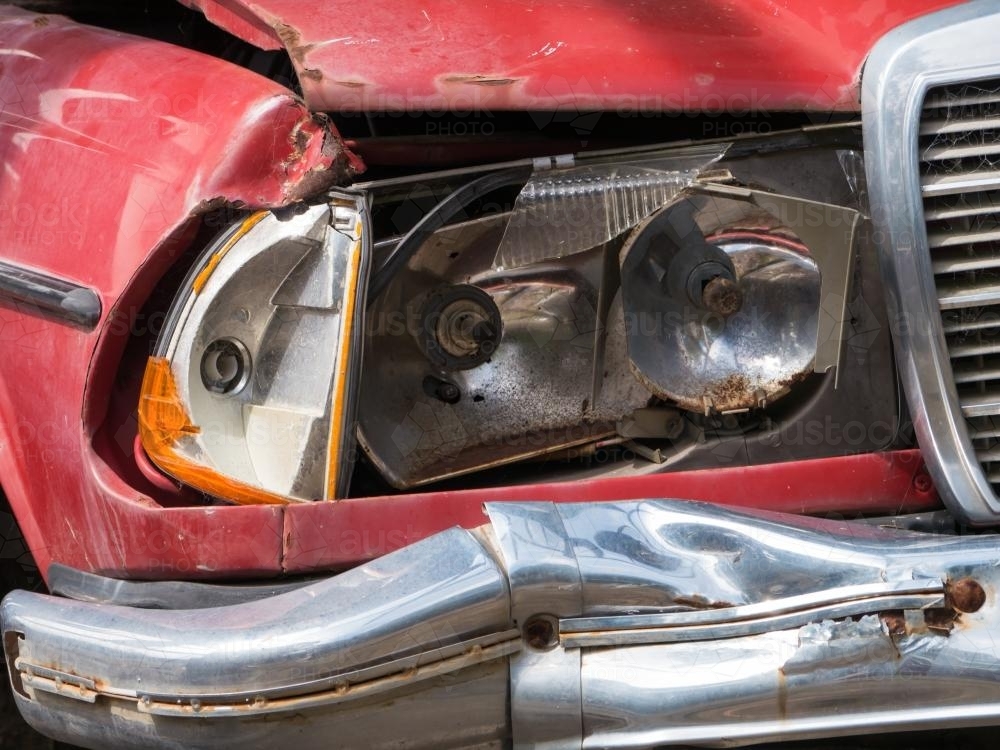 Broken headlight on a red car - Australian Stock Image