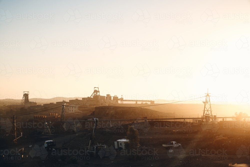 Broken Hill mining operations as sunrise with golden light over machinery - Australian Stock Image