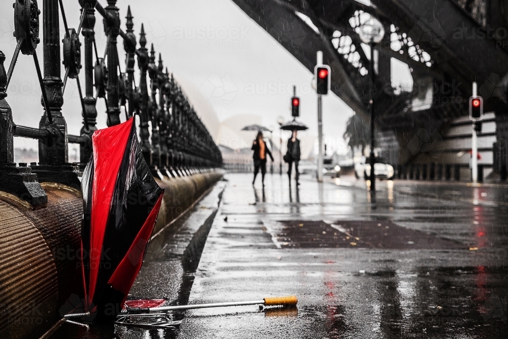 Broken umbrella on city street during Sydney rain storm - Australian Stock Image