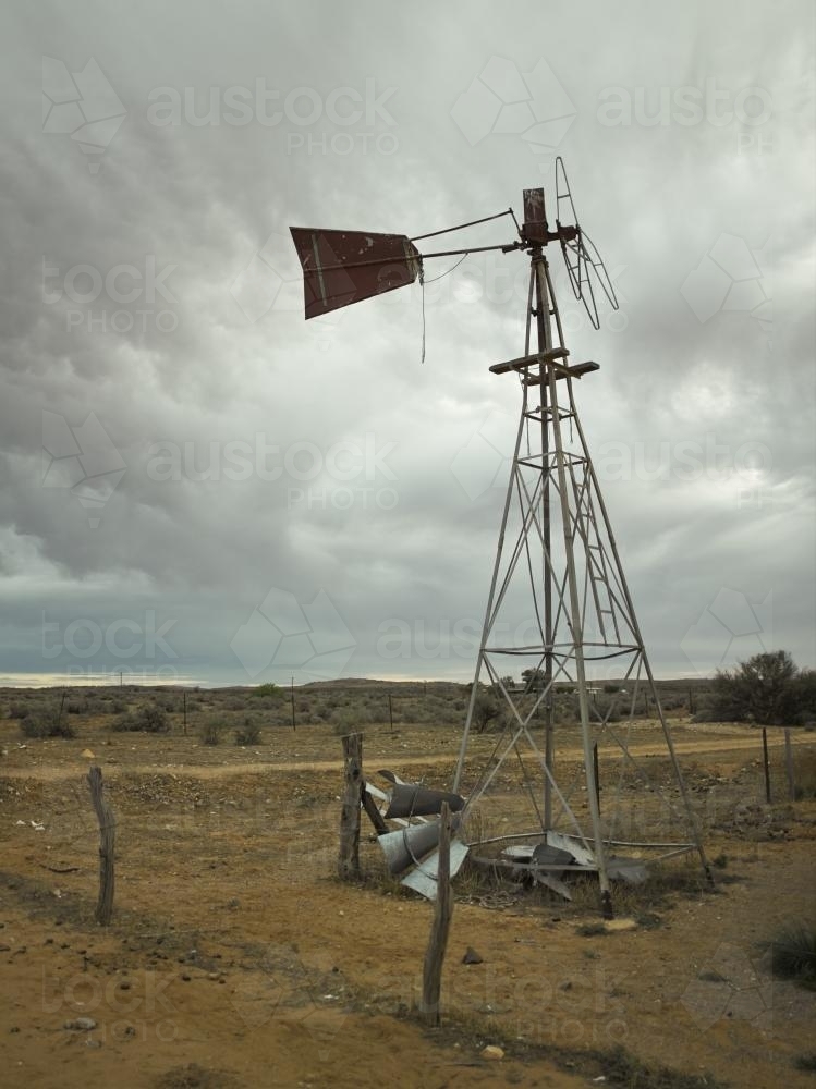 Broken windmill in the outback on a grey day - Australian Stock Image