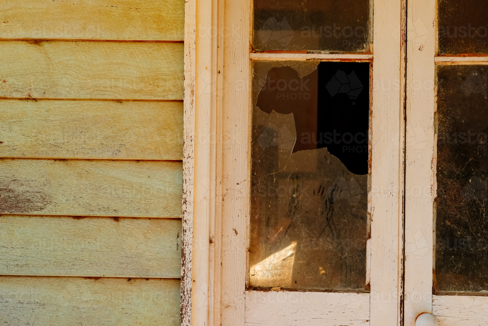 Broken window in a old abandoned house - Australian Stock Image