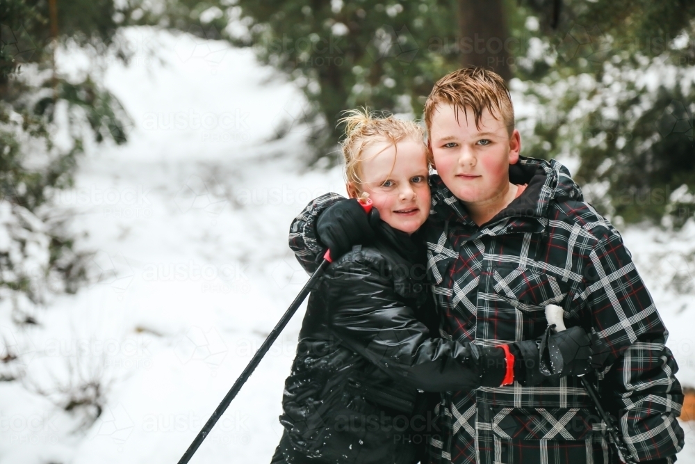 Brothers hugging in the snow, cross country skiing in Victoria's alpine region - Australian Stock Image