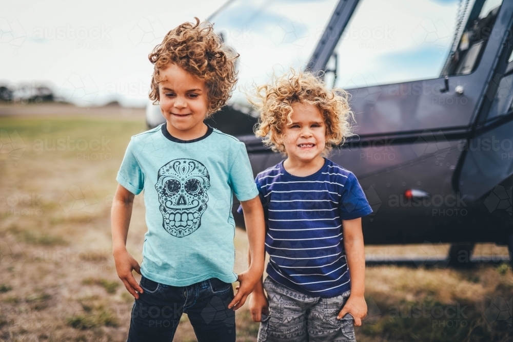 Brothers in front of a helicopter - Australian Stock Image