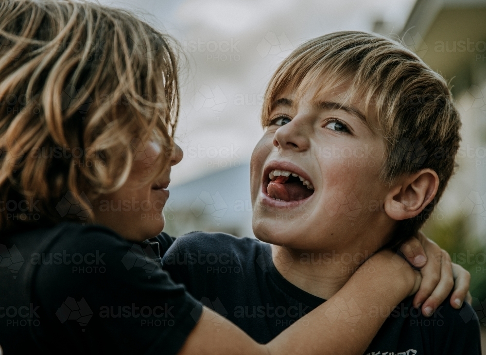 Brothers learning to blow bubbles - Australian Stock Image