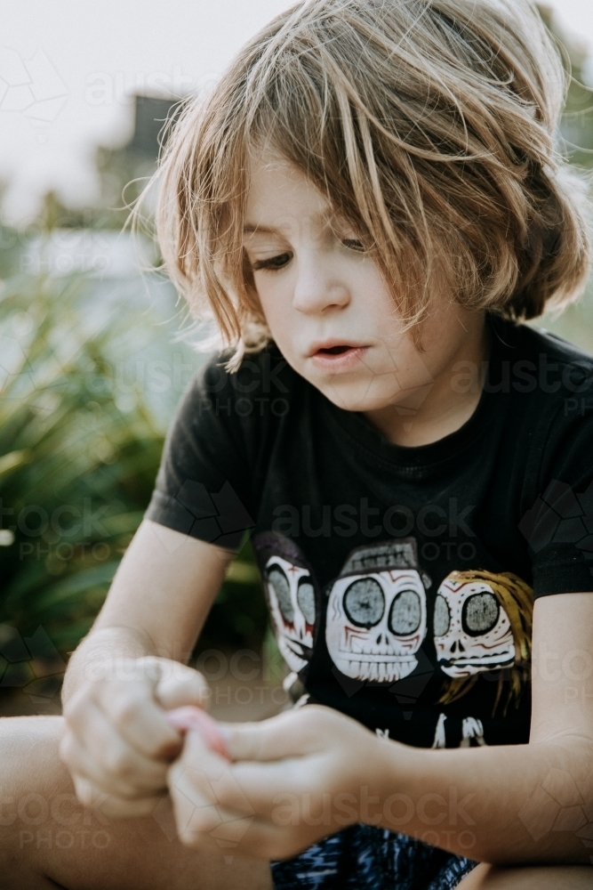 Boy learning to blow bubbles - Australian Stock Image