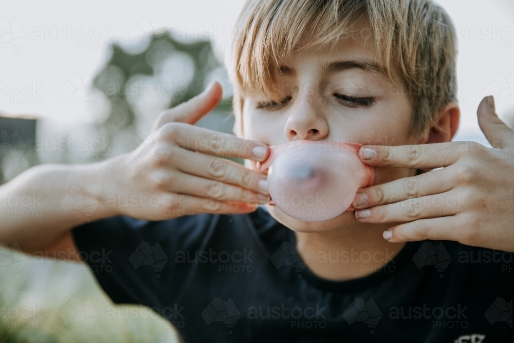 Brothers learning to blow bubbles - Australian Stock Image