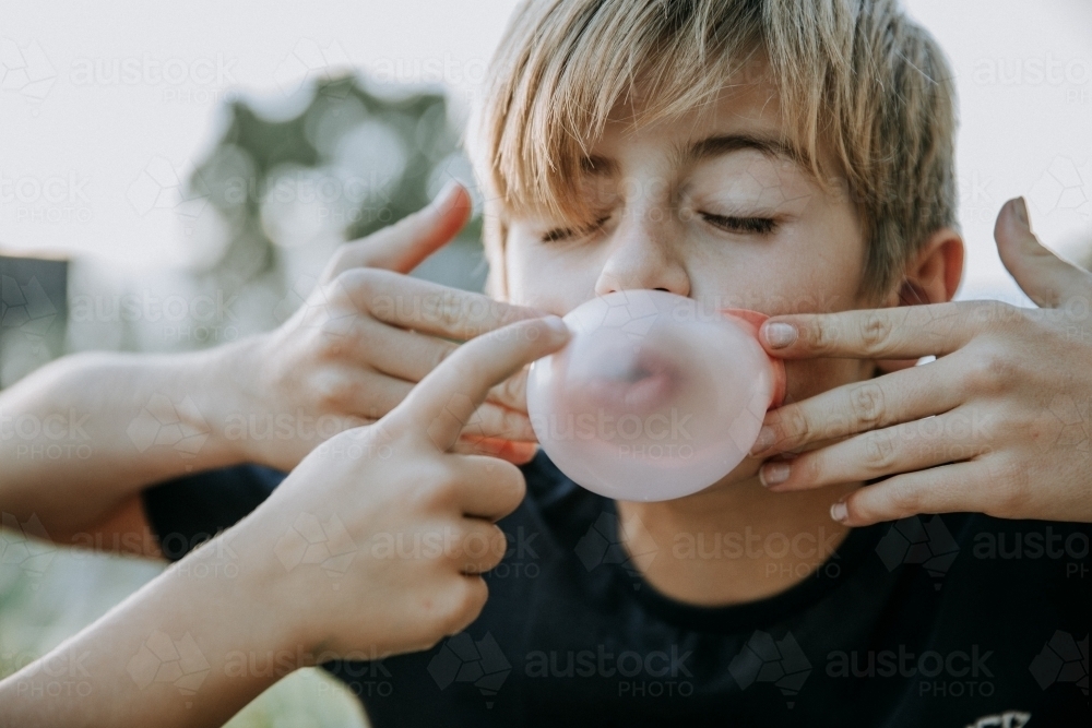 Brothers learning to blow bubbles - Australian Stock Image