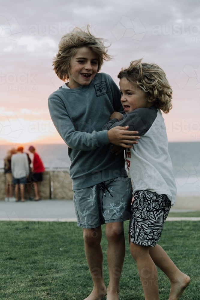 Brothers playing at sunset - Australian Stock Image