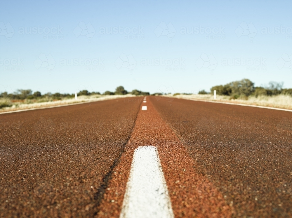 brown bitumen highway in outback - Australian Stock Image