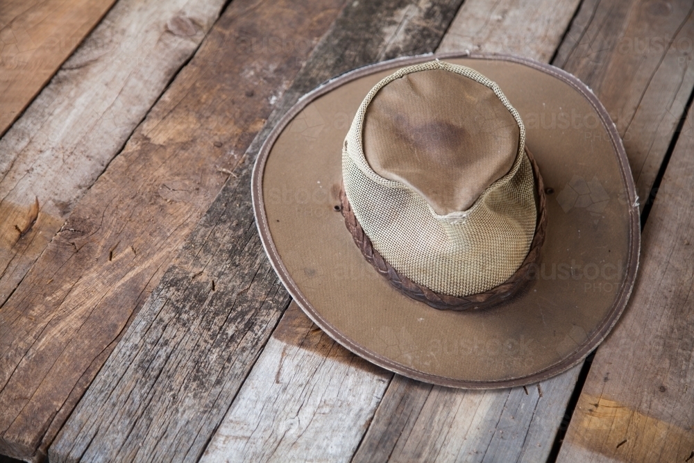 Brown farmers hat lying on old timber boards - Australian Stock Image