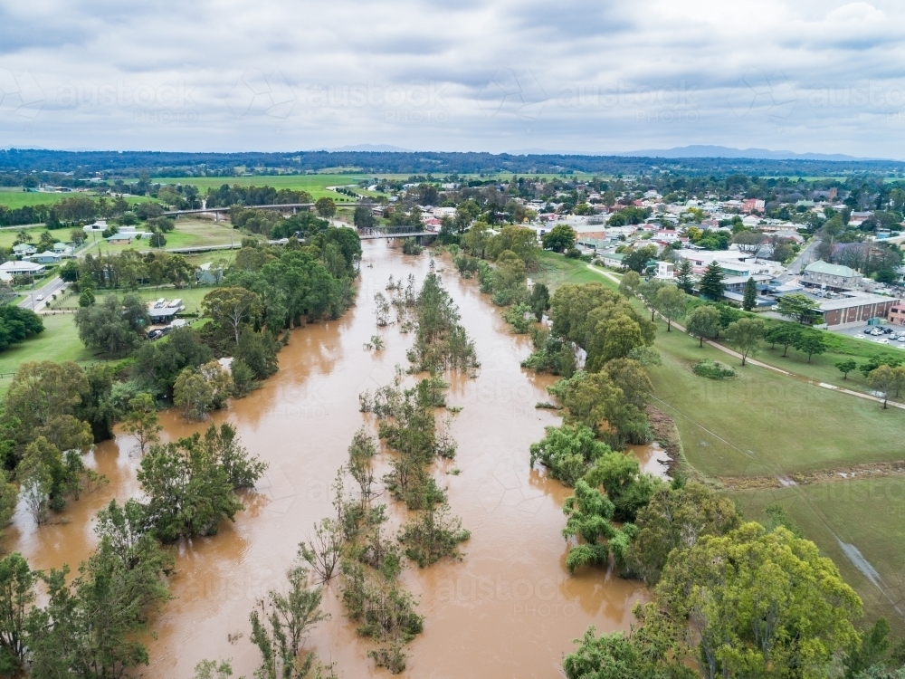 Brown floodwaters in Hunter River water falling after flood - Australian Stock Image