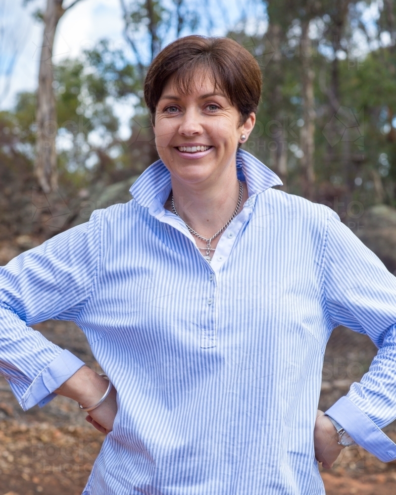 Brown-haired woman smiling outside - Australian Stock Image