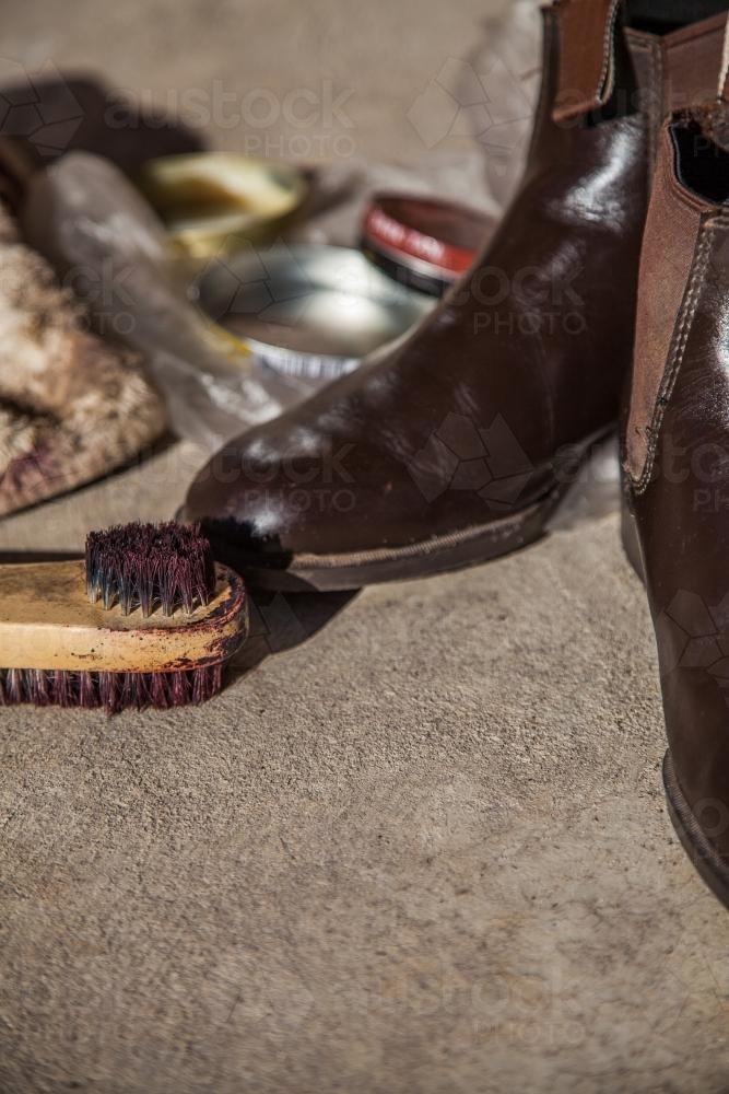Brown leather boots, brush and polish - Australian Stock Image