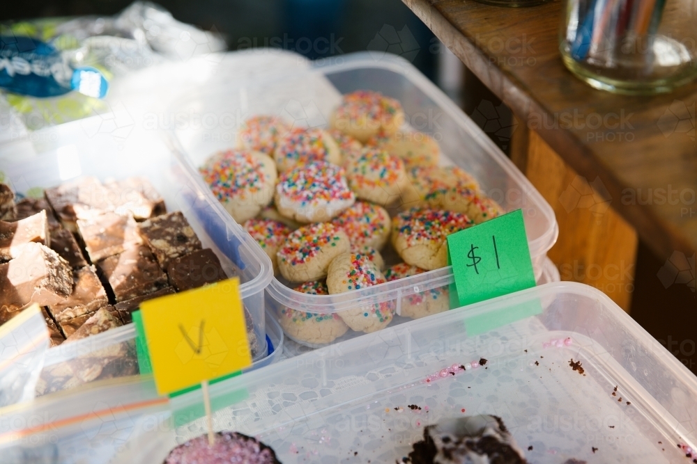 Brownies and sprinkled cookie in a white container with a $1 sign - Australian Stock Image