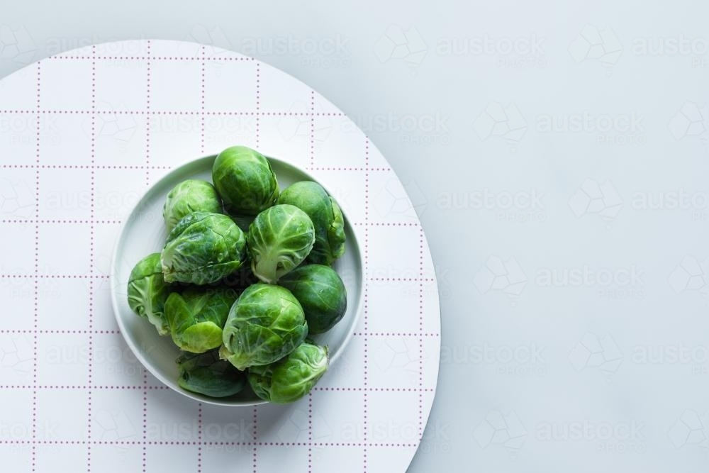 brussels sprouts in a white dish with copyspace - Australian Stock Image