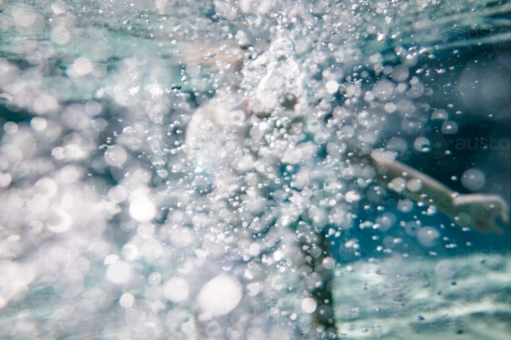 Bubbles under water as kids play in a backyard pool - Australian Stock Image